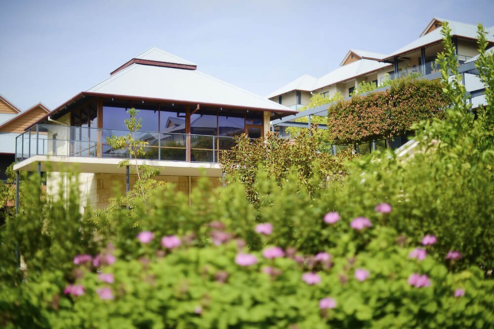 View across lush gardens to elevated apartments at St Ives Centro retirement village