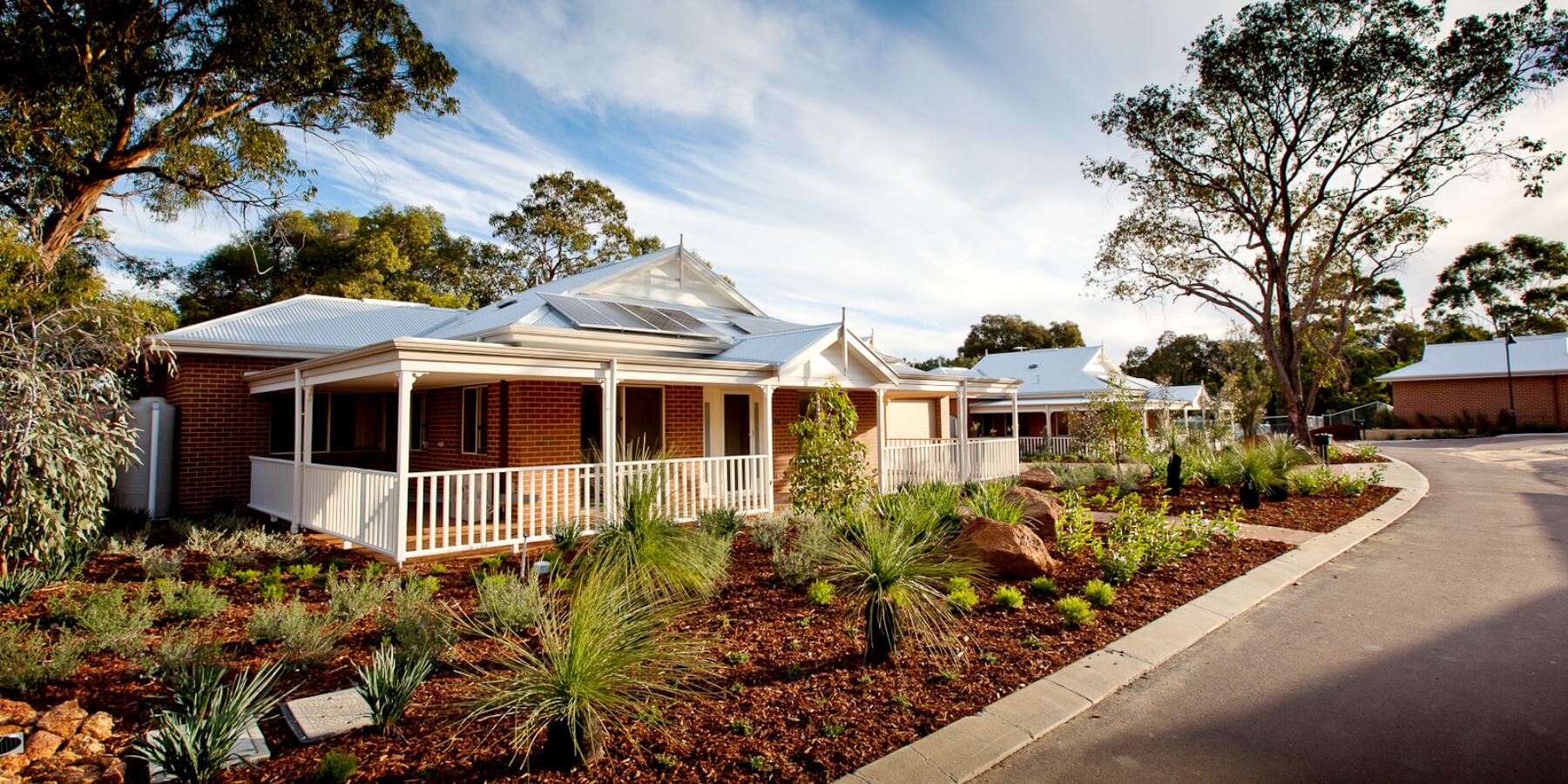Front view of a home with native garden frontage at St Ives Lesmurdie retirement village