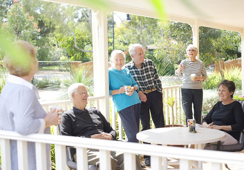 A group of retirees at St Ives Lesmurdie enjoying a cuppa on a verandah