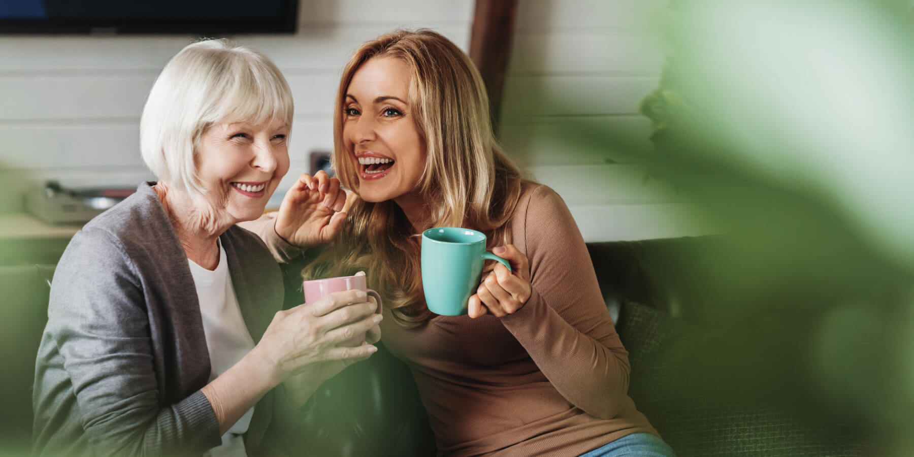 Mother and daughter having coffee together